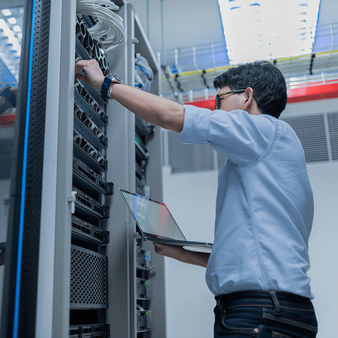 Man holding laptop and setting up a server
